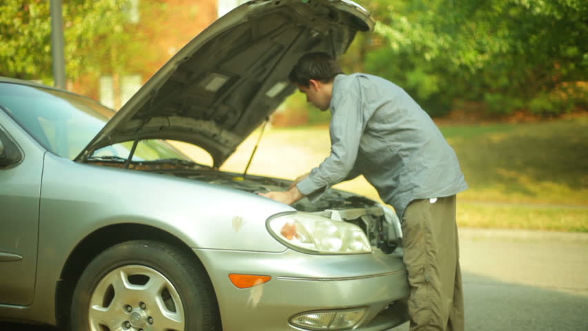 A car broken down on the side of the road