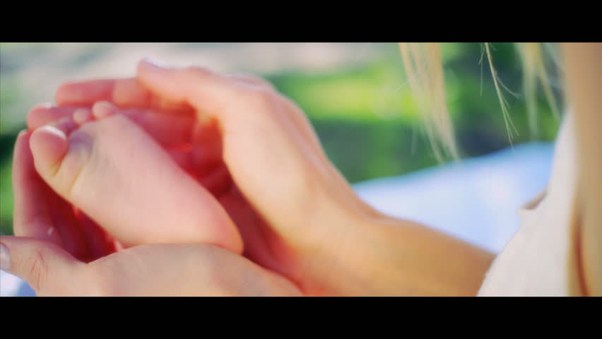 Beautiful young mother and baby laughing together as she is swung up in her mothers arms shot in 5K widescreen RED EPIC