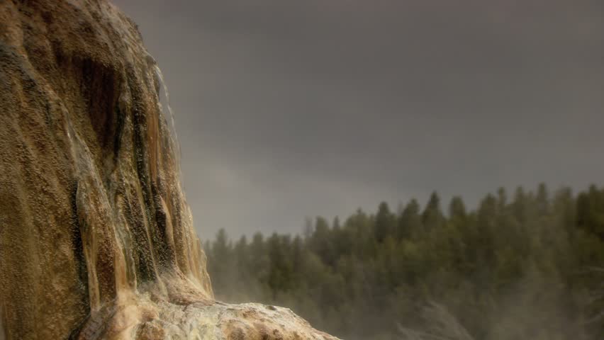 Water spewing out of rock formation in Mammoth Hot Springs Yellowstone 