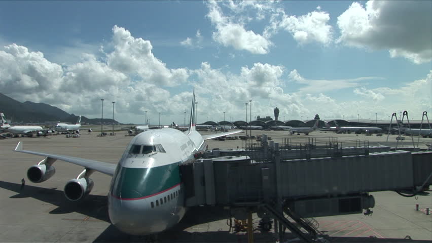 Hong Kong, China - CIRCA April, 2007: A taxied jumbo jet waits on the tarmac for passengers to be loaded onto it on a scenic day