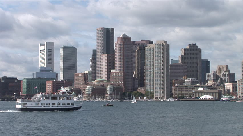 Wide view of the skyline of Boston sitting on the bay seen during the day