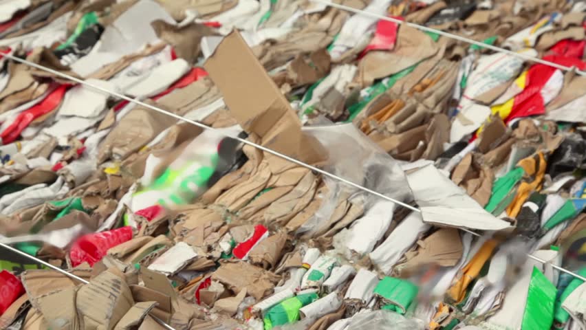 Pile of waste carton for recycling, closeup view in motion
