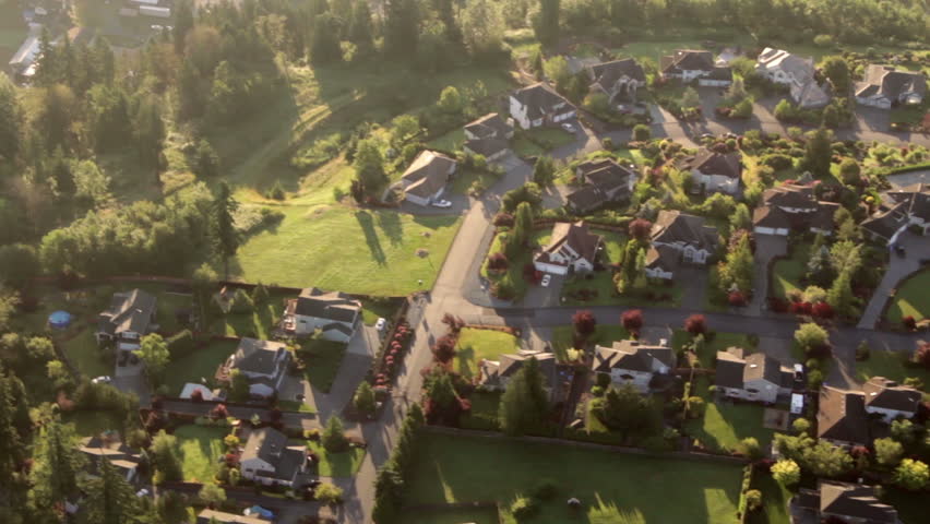 Aerial view from low-flying airplane of residential estates in wealthy neighborhood on a hill