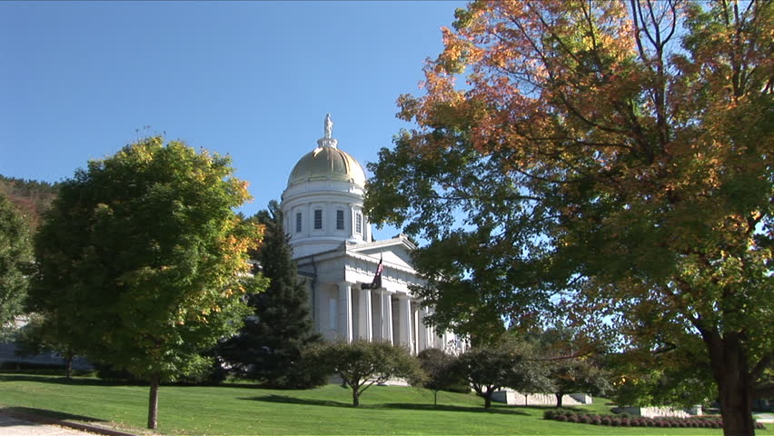 Montpelier, Vermont - CIRCA September 2007: Wide view of the State Capitol Building sitting on a green lawn with trees during the day