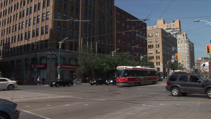 Toronto, Canada - CIRCA October, 2007: A tram makes a turn in an intersection on a busy street during the day