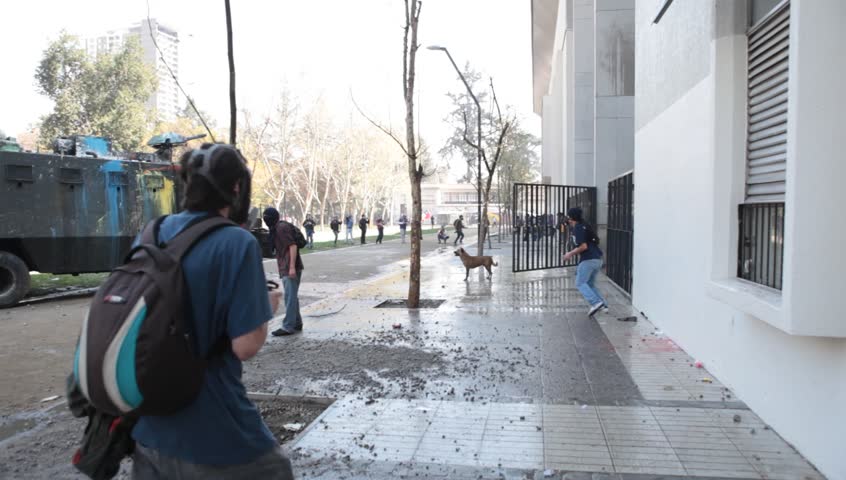 SANTIAGO, CHILE - SEPTEMBER 22: Water cannon truck disperse demonstrators during a student strike on September 22, 2011 in Santiago, Chile. Protesters demand the government to improve educationquality