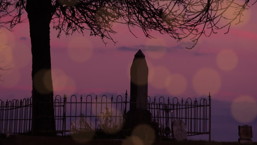 Spooky graveyard at sunset.