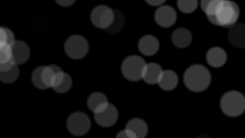 Black and white dots flowing like a Bokeh effect from your camera lens. Seamlessly loops.