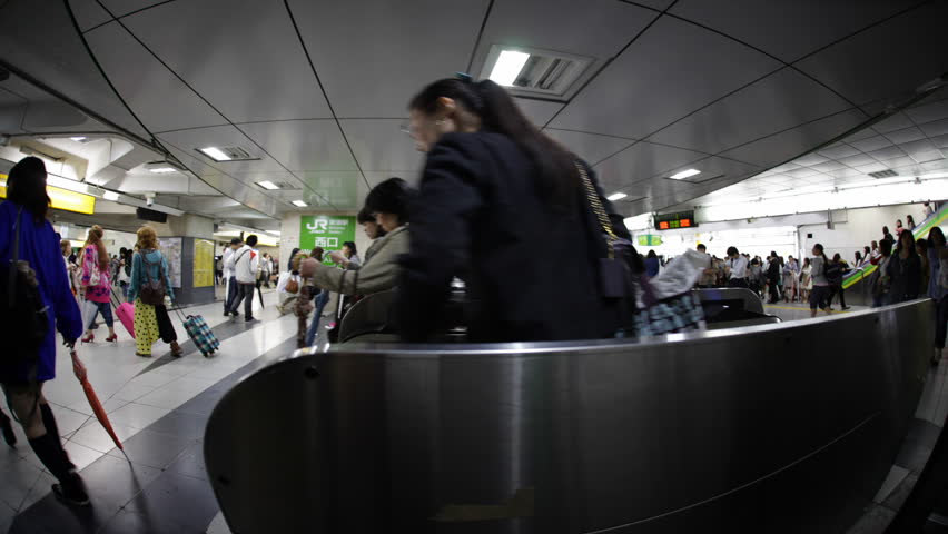TOKYO - JUNE 11: Japanese walking through a ticket gate in Shinjuku, Tokyo on June 11, 2012. With more than 1.5 million passengers per day, Shinjuku is the biggest station in the world.