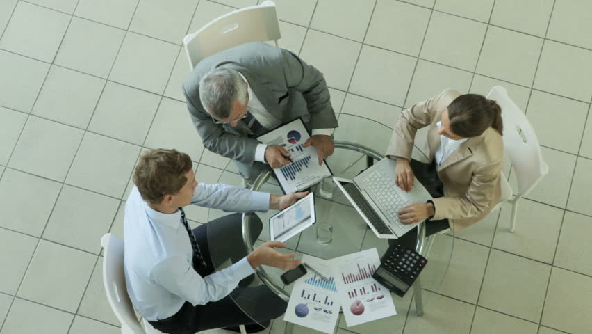 High angle view of a business group analyzing financial data