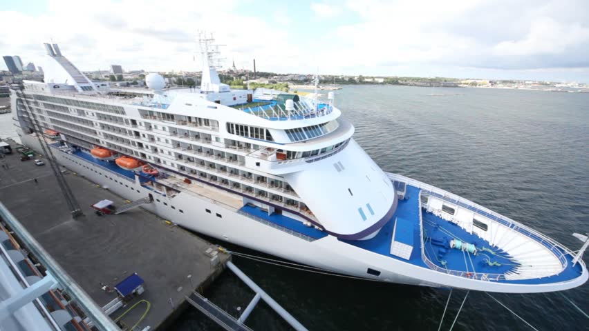 big comfortable passenger liner standing in port of city