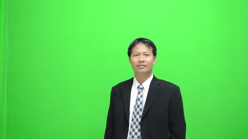 Businessman presenting in front of a green screen 