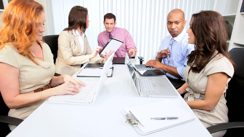 Young advertising agency team using modern wireless technology in conference
