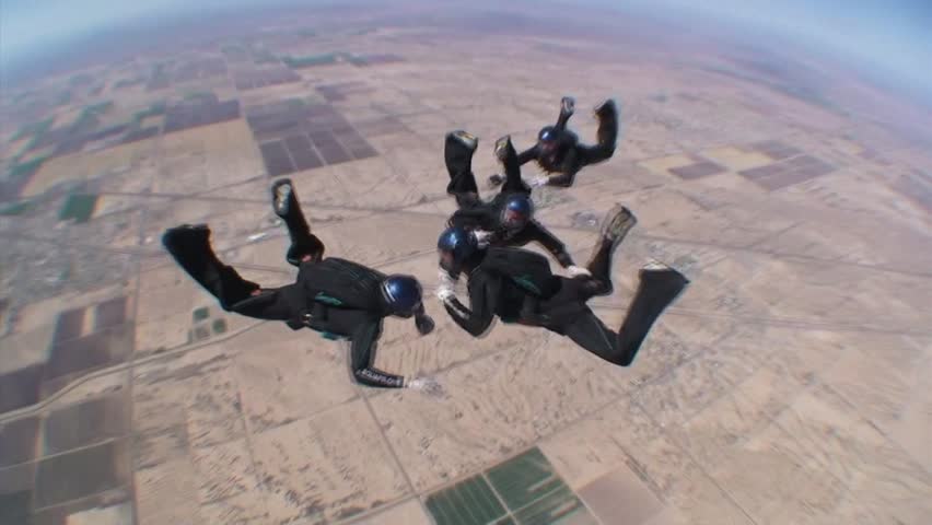 ARIZONA - CIRCA 2010: Four Skydivers Jump And Take Formation 2
