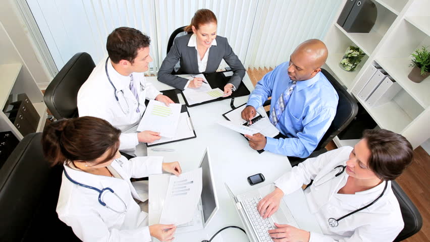 Boardroom meeting young multi ethnic medical executives with hospital financial consultant