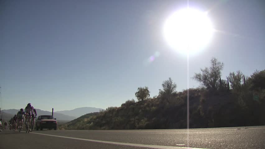 ARIZONA - CIRCA 2010: Cyclists In A Road Race As They Climb A Hill 