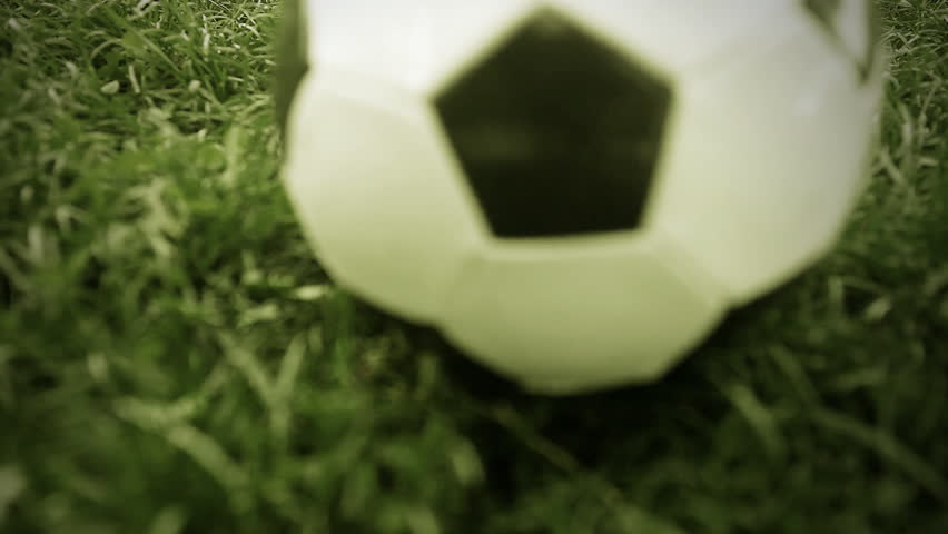 Soccer ball on the grass of football field
