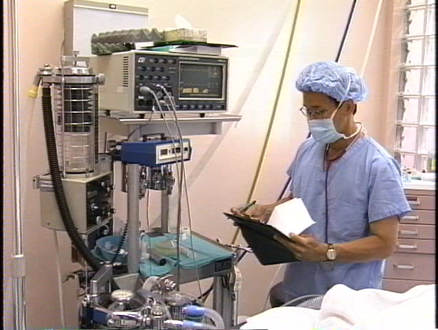 Nurse in front of medical apparatus