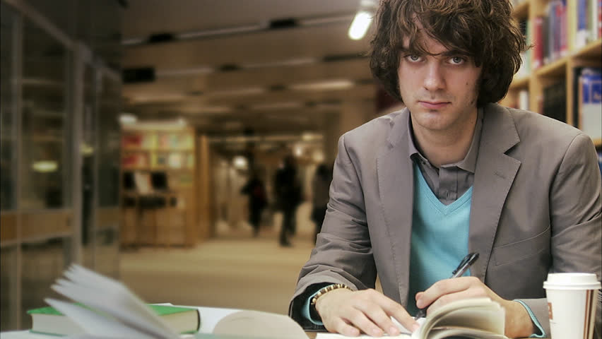 Male pensive student in a library, Sweden.