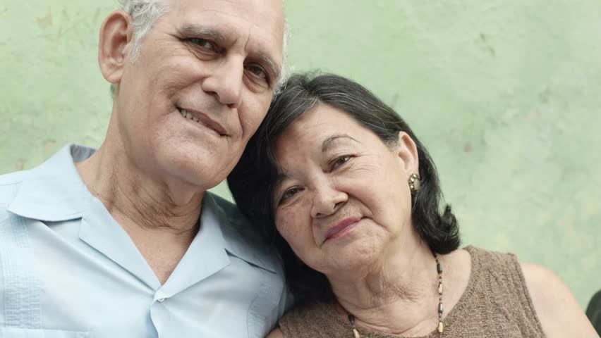 Old people in love, happy senior man and woman hugging and smiling in front of camera. Slow motion