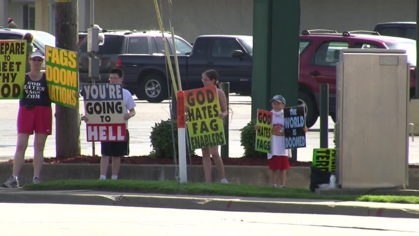 TOPEKA, KS - CIRCA 2009: Members of the Westboro Baptist Church, including children, protesting on a street corner circa 2009 in Topeka, KS.