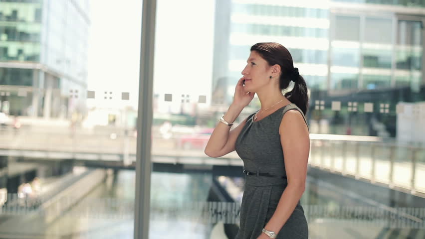 Businesswoman walking and talking on cellphone