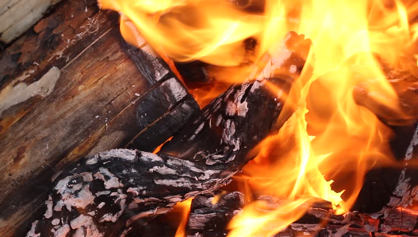 Flames engulfing wood in a fire