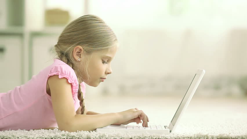 Little lady being busy typing on her laptop