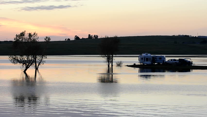YUBA CITY, CALIFORNIA-CIRCA 2011-Campers watching the sunset from their RV at Far West Reservoir near Spenceville Wildlife Area, Yuba City, California.