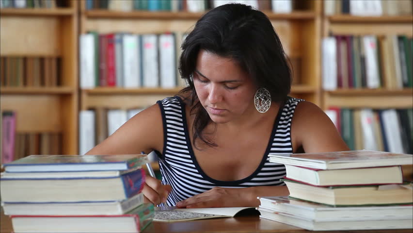 tired beautiful girl student in the library 