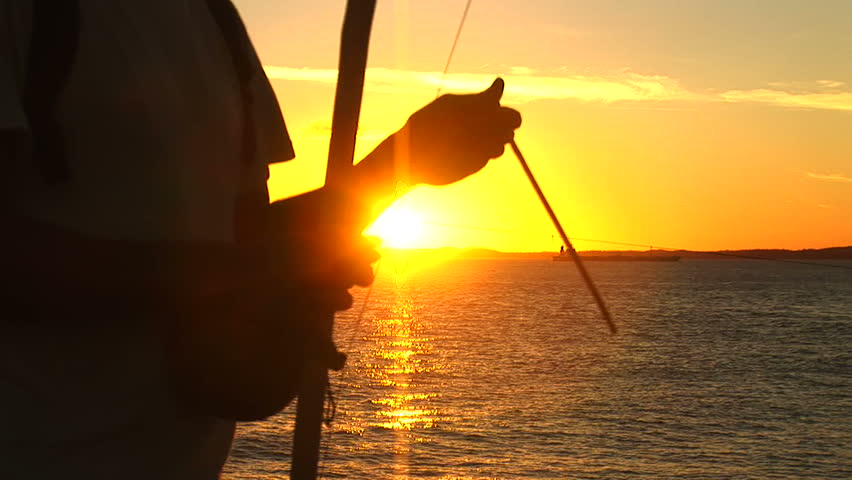 Silhouette of a man playing Berimbau in Salvador, Brazil