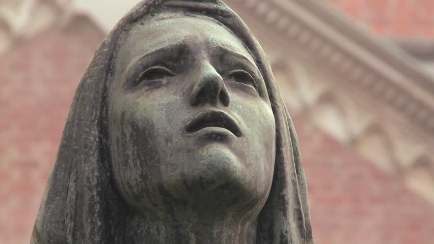 MILAN, ITALY-CIRCA 2011-A statue of a woman weeping in a cemetery or church.