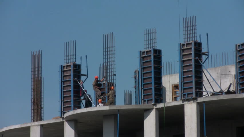 Workers poured concrete at a construction site