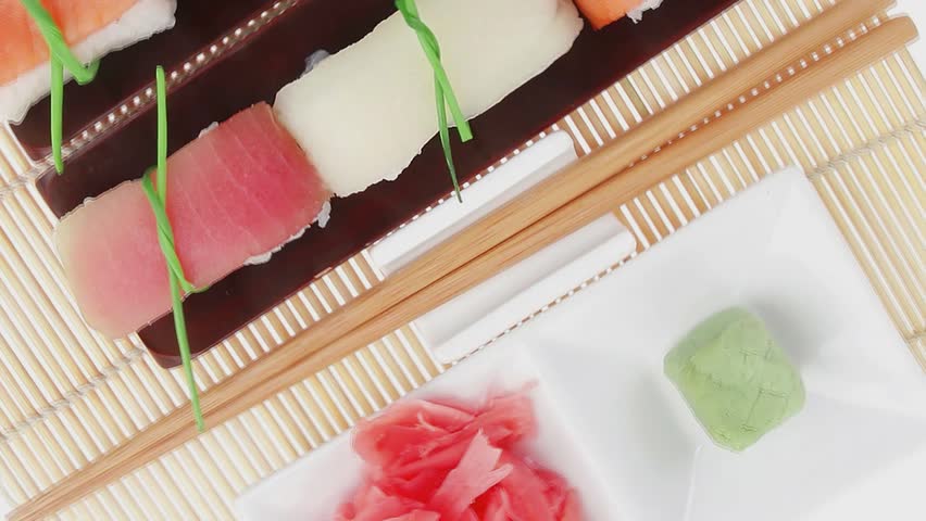 Japanese traditional cuisine - Set of Tuna (maguro) Salmon (sake) and Eel (unagi) Nigiri Sushi  with Wasabi  and Ginger on bamboo mat isolated over white background