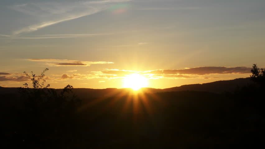 Timelapse from a sunset above the hills. Shooting stars can be seen.