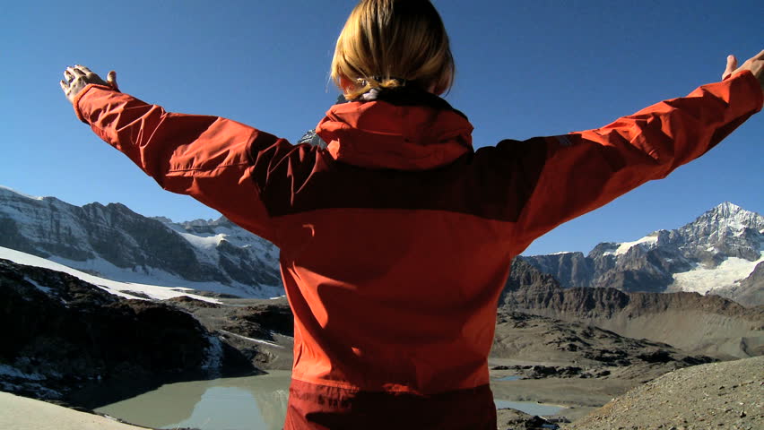 Young woman climbing to the mountain