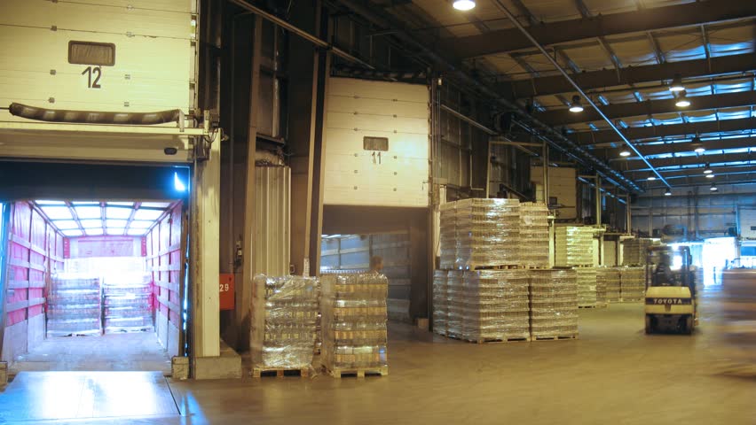 MOSCOW - MAY 31: (Timelapse View) Loader transports containers with quass in lorry at nonalcoholic plant Ochakovo, on May 31, 2012 in Moscow, Russia