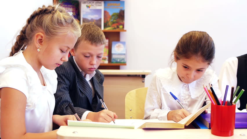 Serious pupils writing task in the classroom