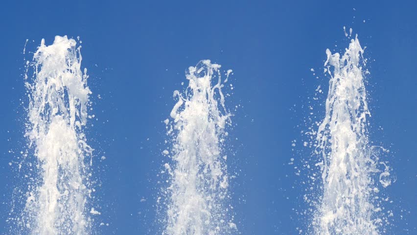 three top fountain water against blue sky