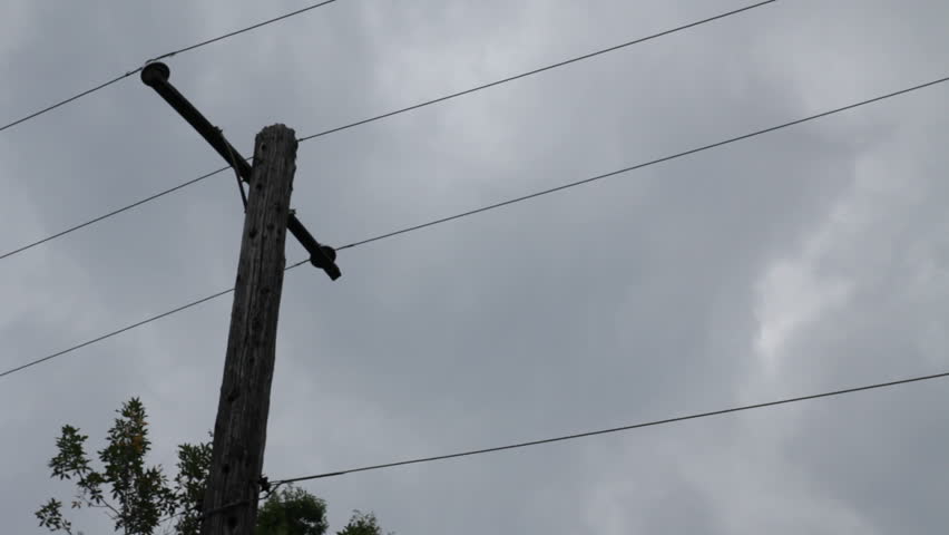 Telephone pole silhouette slow clouds left offset
