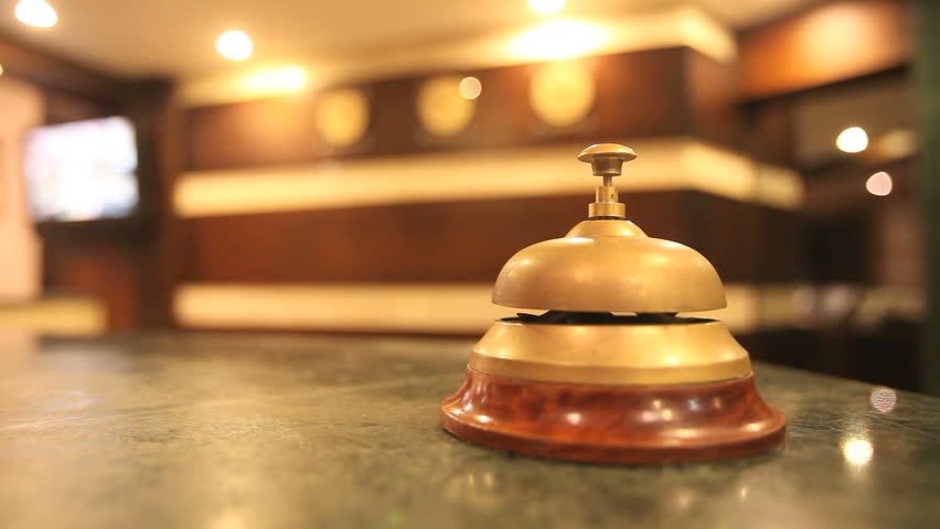 call on a old hotel bell on a wood stand