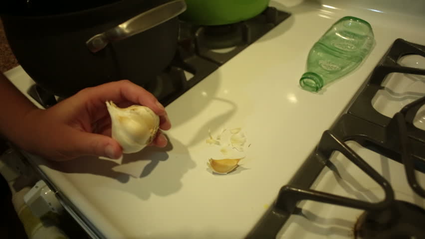 Cutting garlic for a recipe.
