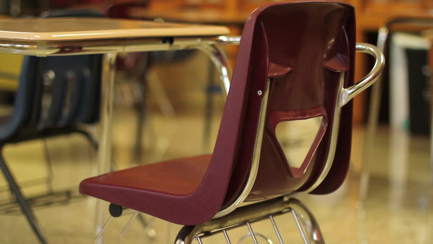 Classroom desk and chair - Dolly shot. Classroom desk and chair close up using a dolly.