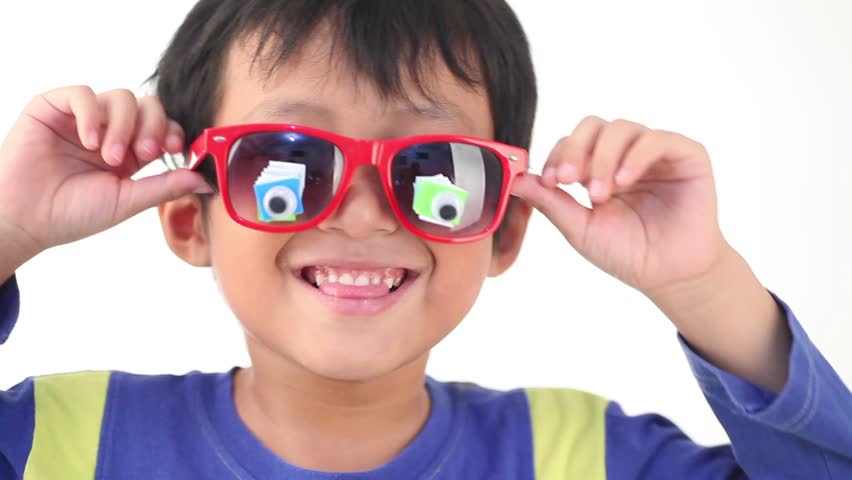 Happy and cute Asian boy making silly faces filmed over white background