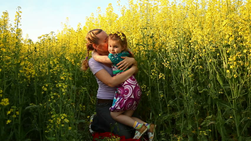 Mom and daughter in a field of flowers