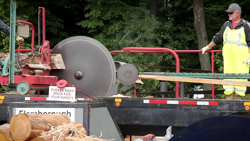 WATERLOO, ONTARIO - SEPTEMBER 21: Man operating an old-fashioned pony saw mill on September 21, 2012 in Waterloo, Ontario. This 150-year-old technology was the primary method of sawing lumber.