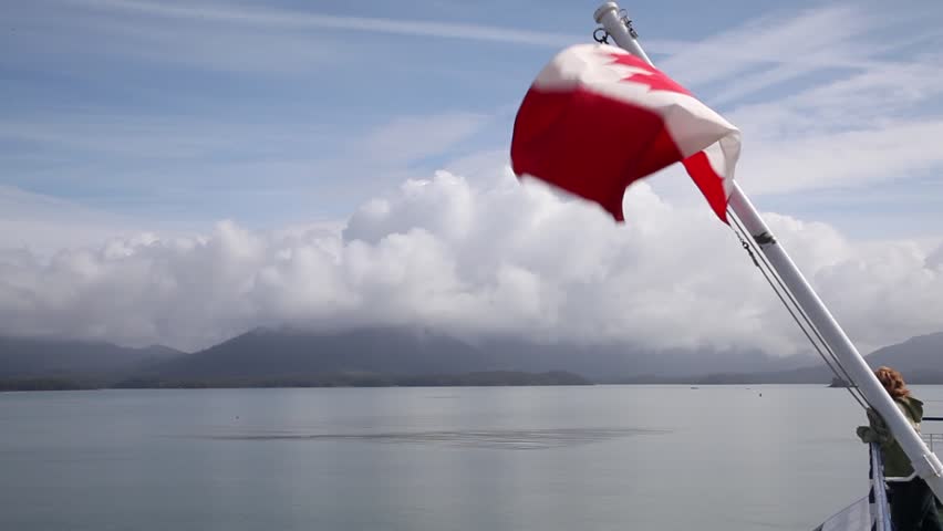 Canadian flag blowing in breeze on a ferry