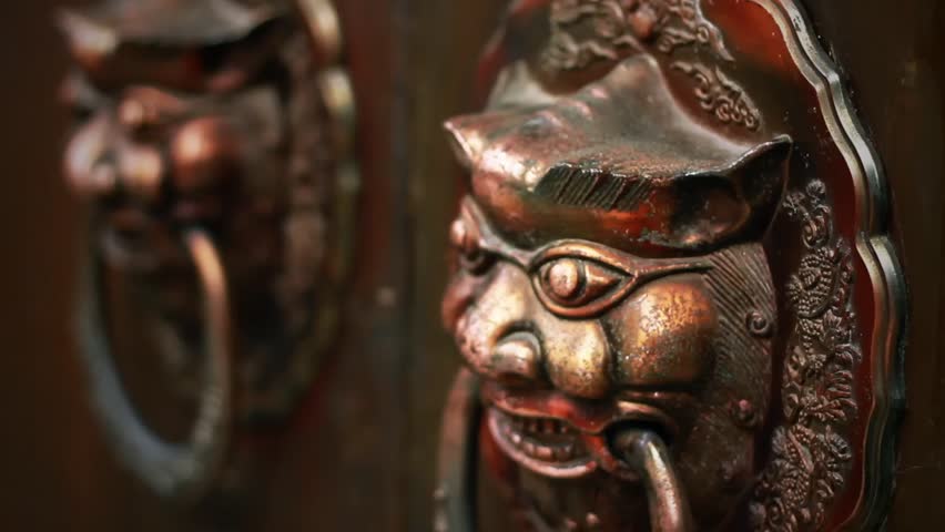 CHENGDU, CHINA - SEPTEMBER 10: Lions knocker of old door in the "Kuan Alley & Zhai Alley" historical culture protectorate on September 10, 2012 in Chengdu, China.