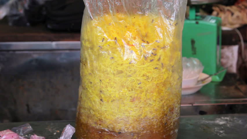a bag of yellow noodles with bugs inside