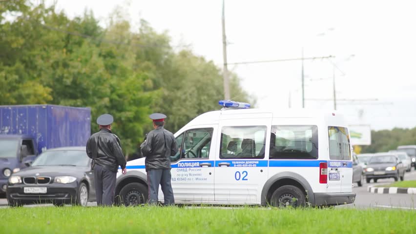 MOSCOW - September 07: Road police officers on duty near police car on crossroad on September 07 , 2012 in Moscow,  Russia.